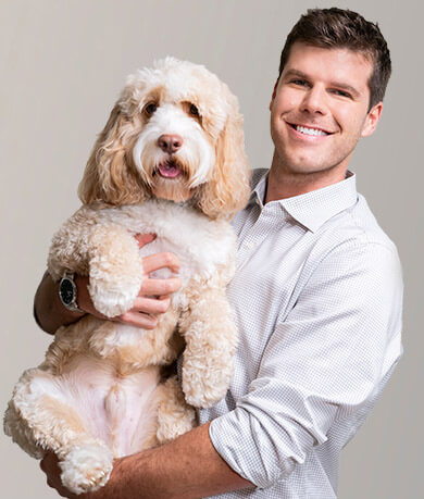 Michael Lazaris holding puppy